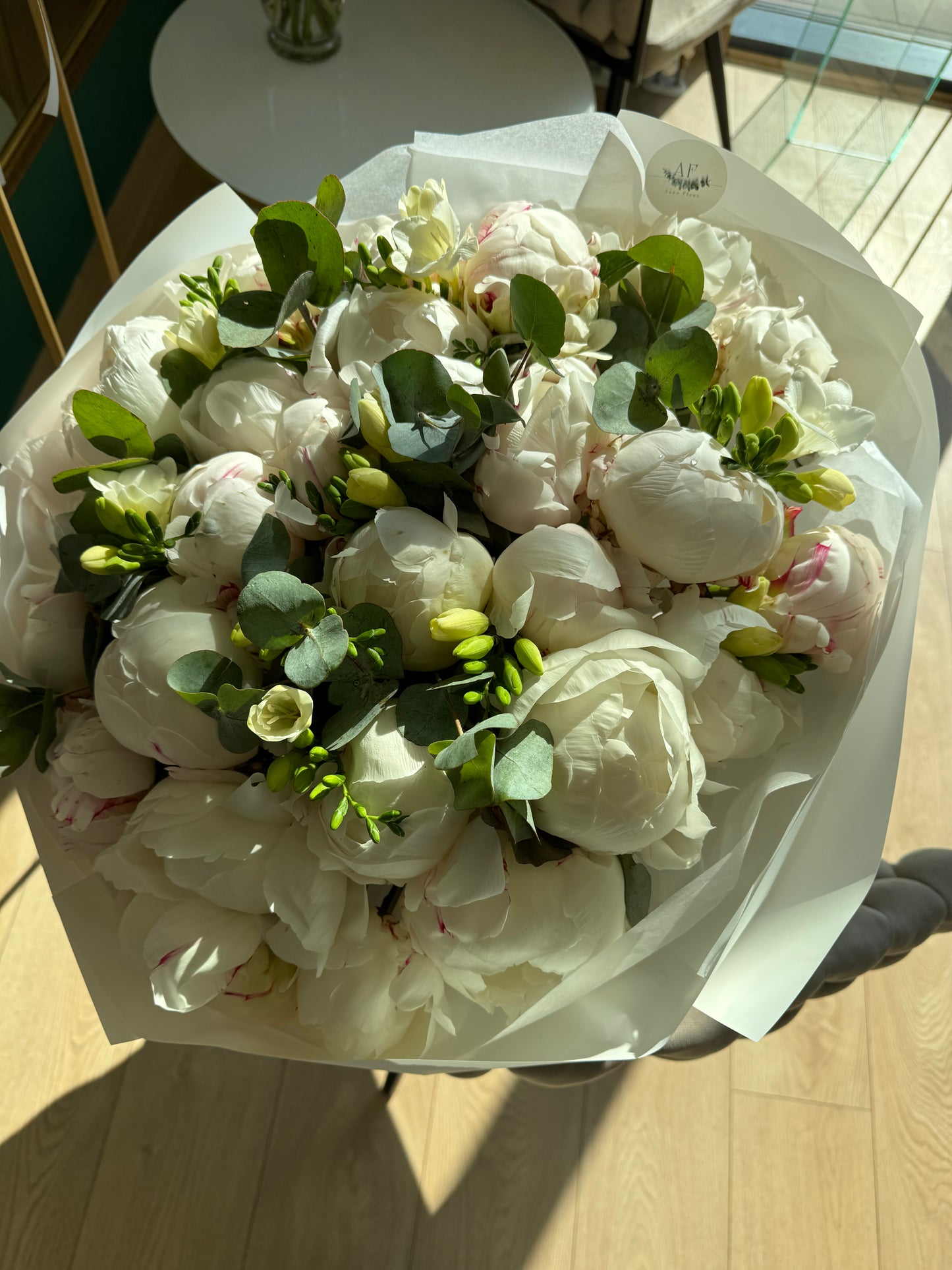 Bouquet of peonies eucalyptus and freesias